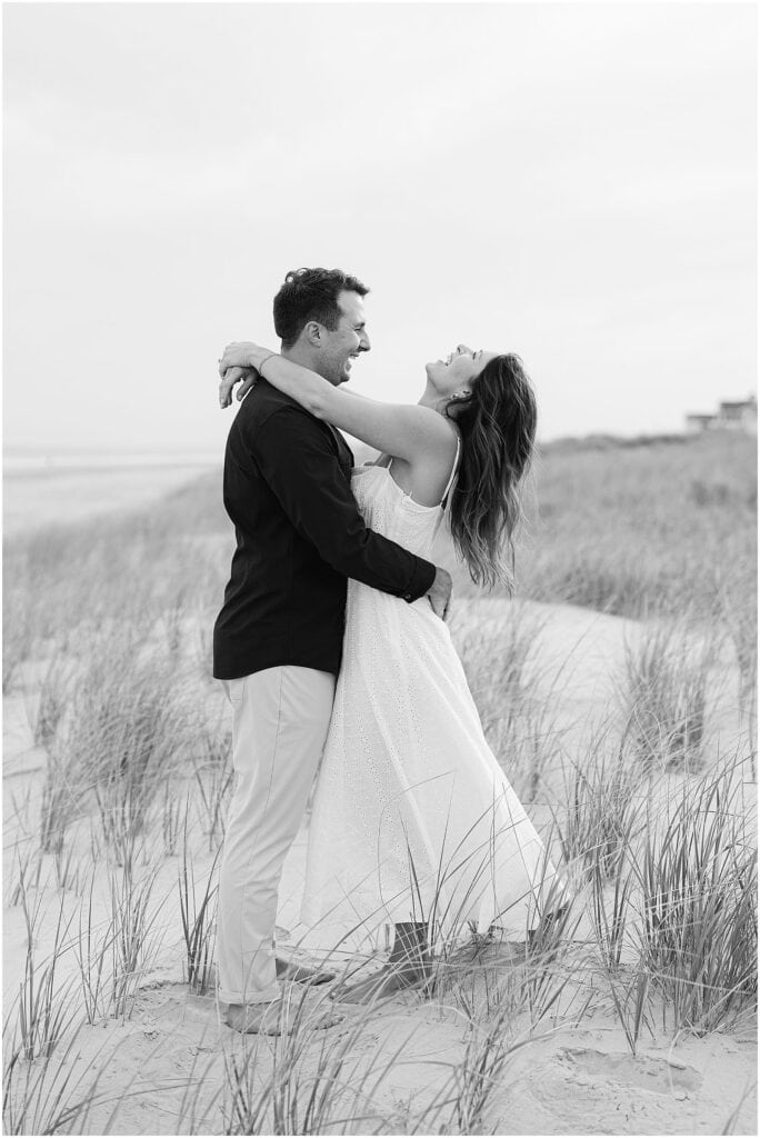 engaged couple laughing at the jersey shore